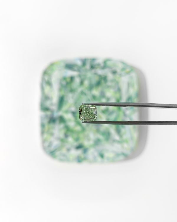 Green diamond in front of Angie Crabtree's painting. (Angie Crabtree)