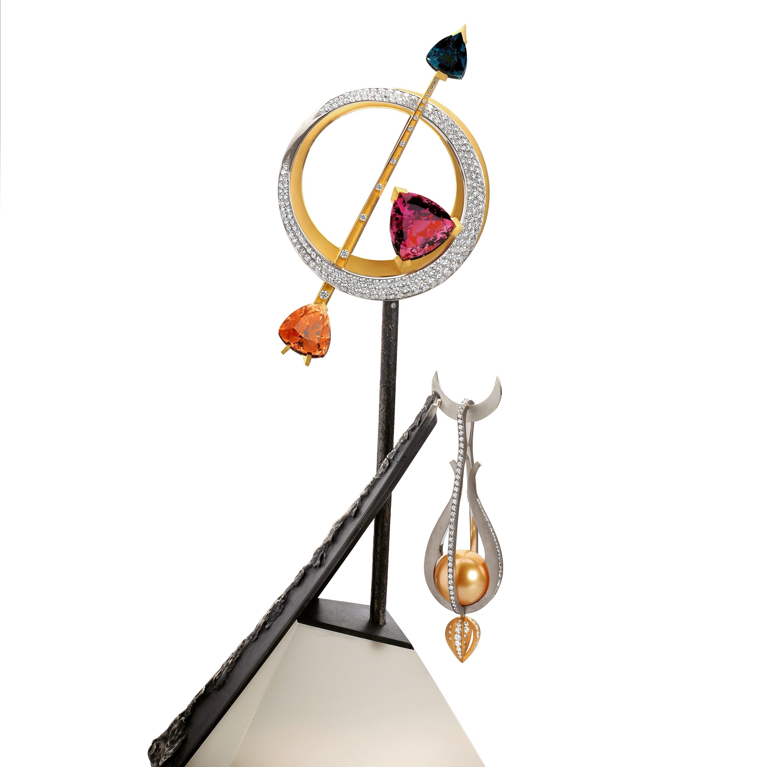 Susan Helmich "Onto Neverland" object d'art set with apricot, deep cinnamon-red and indicolite blue tourmaline, on a rock crystal base carved by Tom Munsteiner which secures 8 carats of diamonds set in 18-karat gold. Finished with a pendulum of platinum and a golden orb by Eddie Sakamoto.