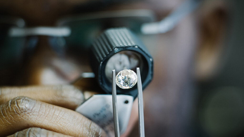 Diamond being inspected with tweezers image