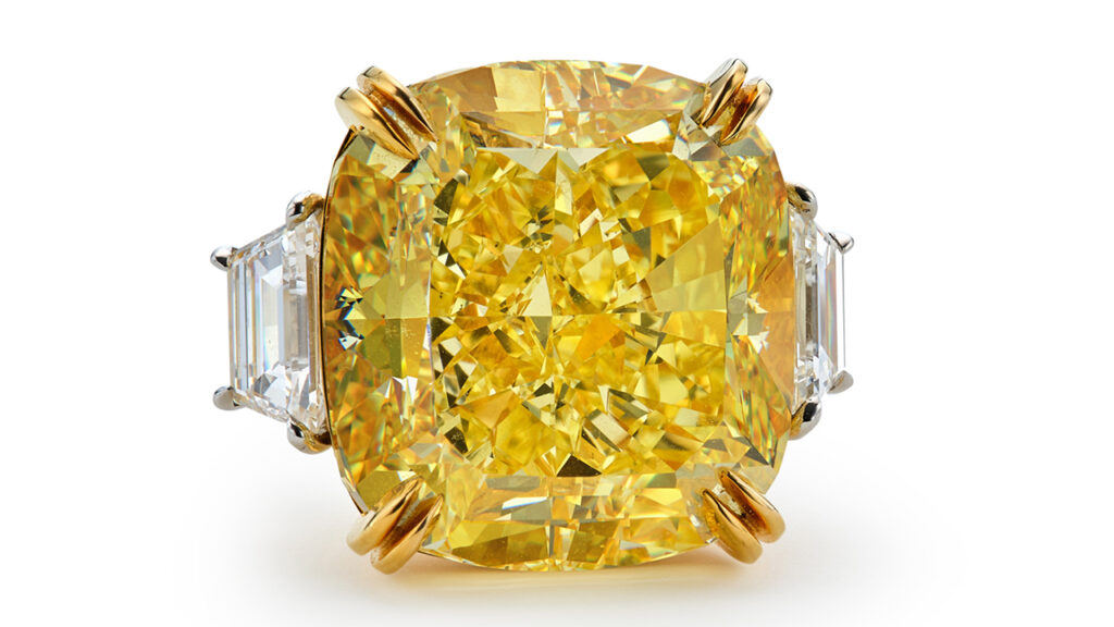 Yellow diamond with two trapeze-shaped diamonds ring image