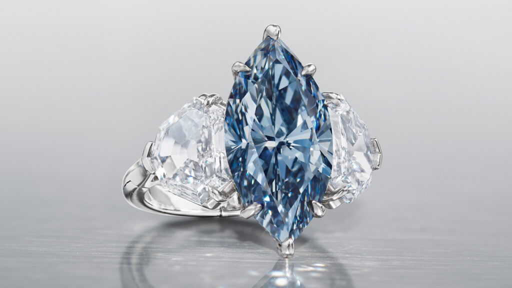 Ring, with a marquise brilliant-cut internally flawless center stone, flanked by trilliant-cut white diamonds at Christie’s image