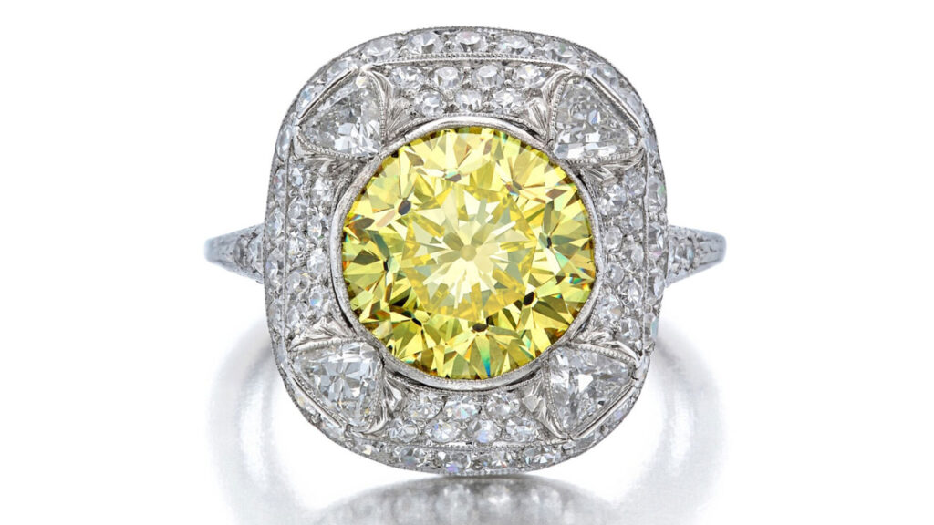 Fancy-vivid-yellow diamond center stone, surrounded by single-cut diamonds ring at Sotheby's image