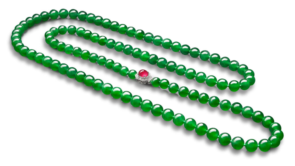 Necklace composed of 108 jadeite beads and a clasp set with a cabochon ruby and brilliant-cut diamonds image.