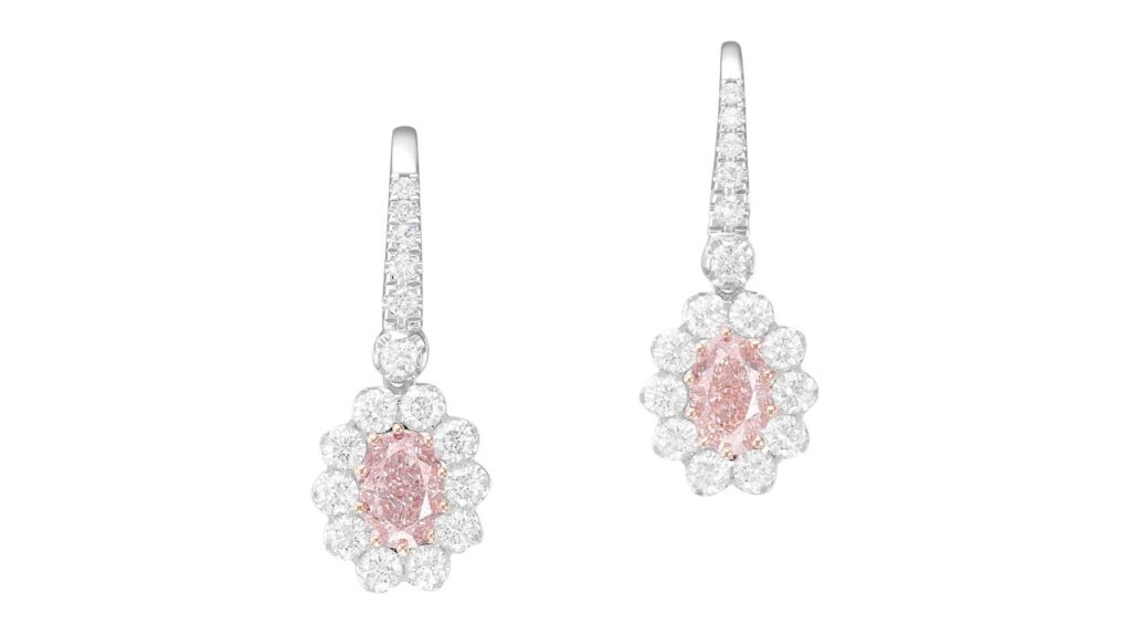 Pair of earrings, each containing an oval-cut, fancy-pink diamond within a diamond surround at Phillips image