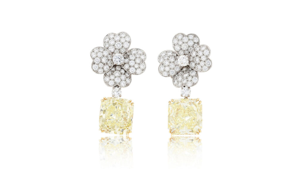 Earrings featuring rectangular step-cut diamonds weighing dangling from removable flowers at Sotheby's image