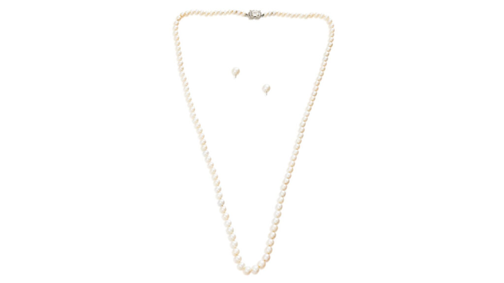 Cartier set comprises a necklace with a row of graduated natural pearls and matching pearl earrings at Sotheby's image