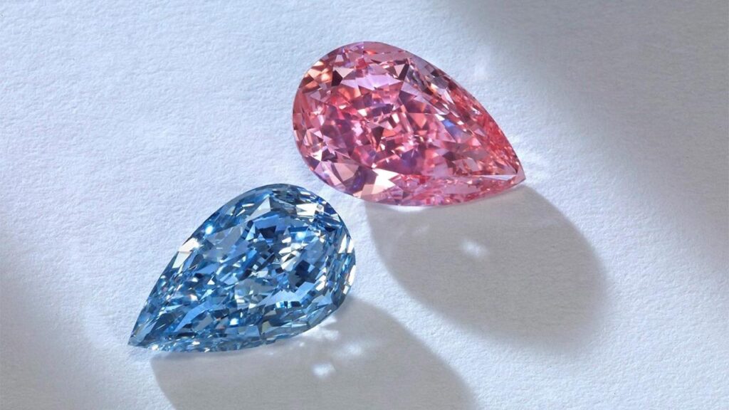 A pink and blue colored diamonds pictured side by side