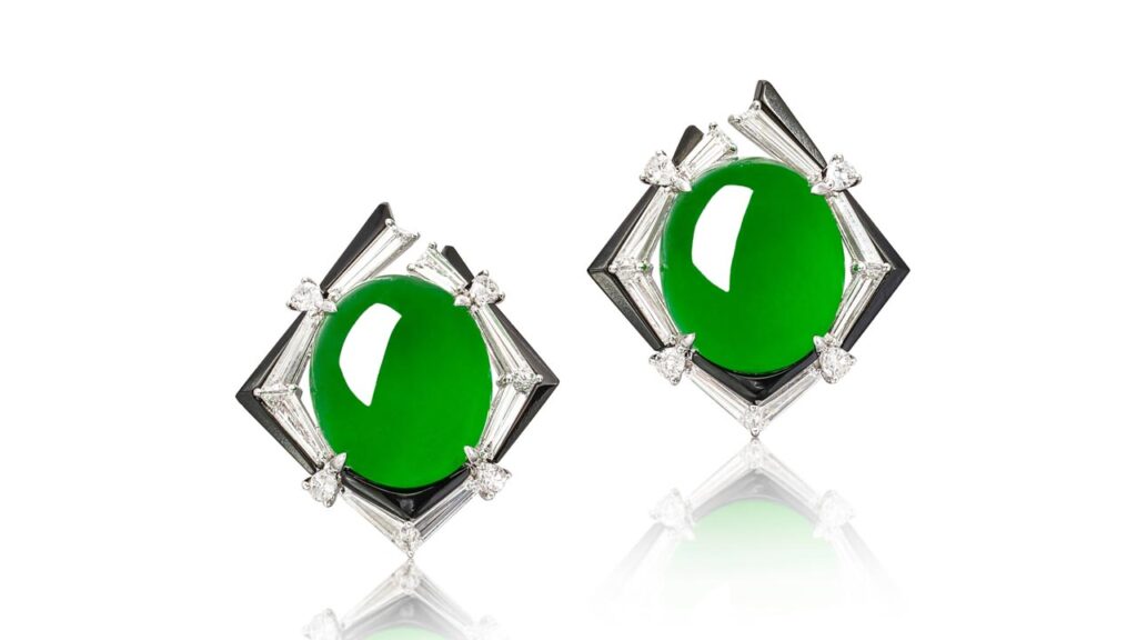 Earrings, each containing a jadeite cabochon within a tapered baguette, pear-shaped diamond and onyx-set border at Sotheby's image