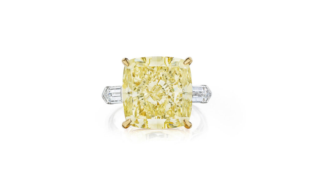 Ring with a cushion-shaped, fancy-yellow diamond flanked by two bullet-shaped diamonds at Bonhams image