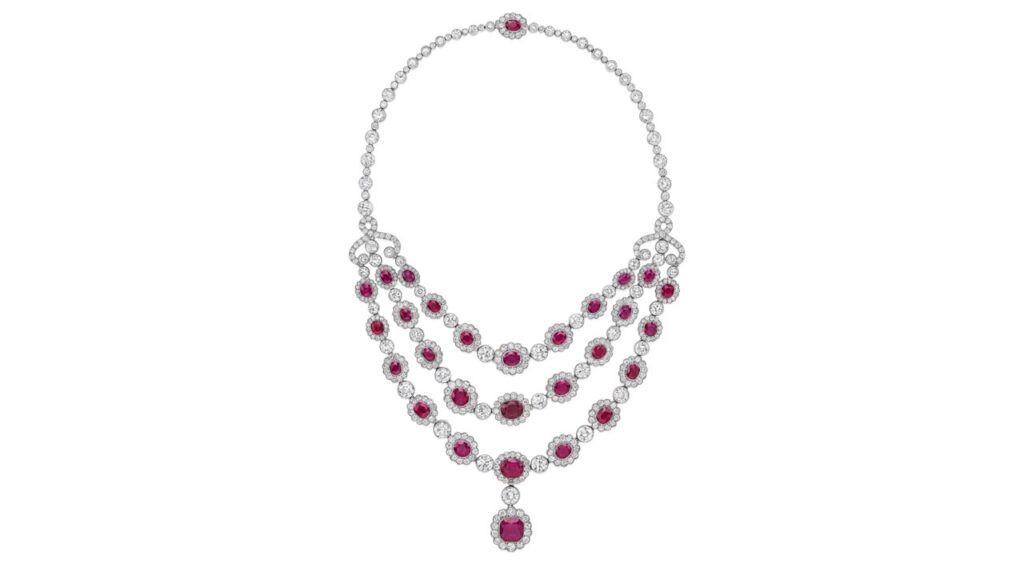 Necklace sporting a ruby pendant and three rows of graduated oval-shaped Burmese rubies, with each stone in a circular-diamond surround at Bonhams image