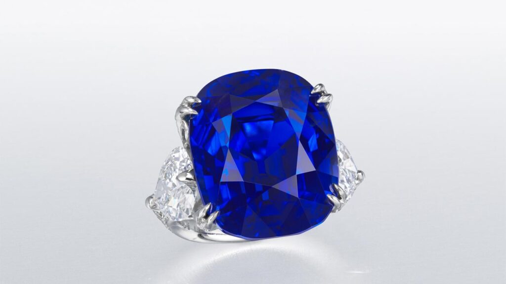 Ring featuring an antique cushion brilliant-cut Burmese sapphire center stone bracketed by heart-shaped and round diamonds at Christie's image