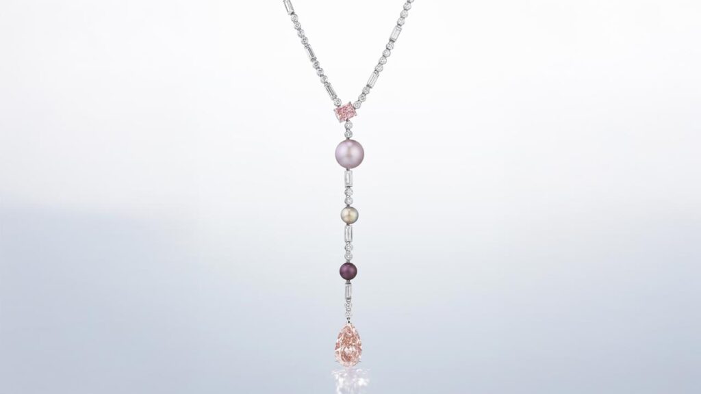 Cartier necklace featuring a pear modified brilliant-cut fancy-intense-orangey-pink diamond, a cut-cornered rectangular modified brilliant-cut fancy-intense-pink diamond and variously colored button-shaped natural pearls at Christie's image