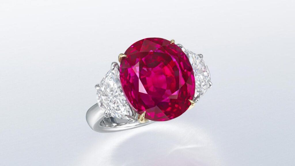 Ring featuring an oval brilliant-cut, Burmese ruby and half-moon diamond side stones at Christie's image