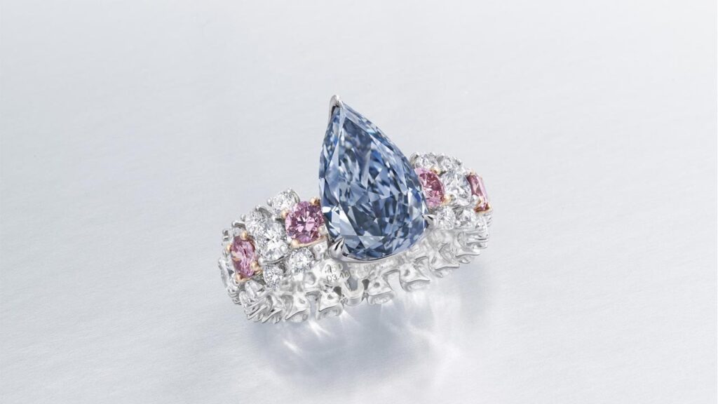 Ring with a pear modified brilliant-cut, fancy-deep-blue, internally flawless center stone with round pink and white diamonds at Christie's image