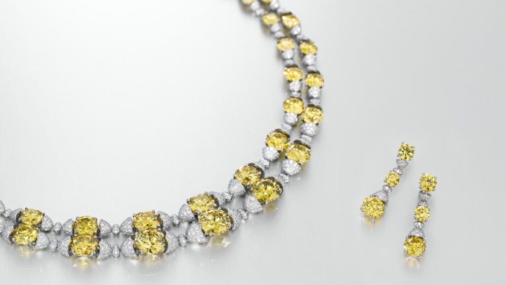 Jewelry set by designer Asprey, comprising a necklace and earrings with fancy-vivid-yellow diamonds and round white diamonds at Christie's image