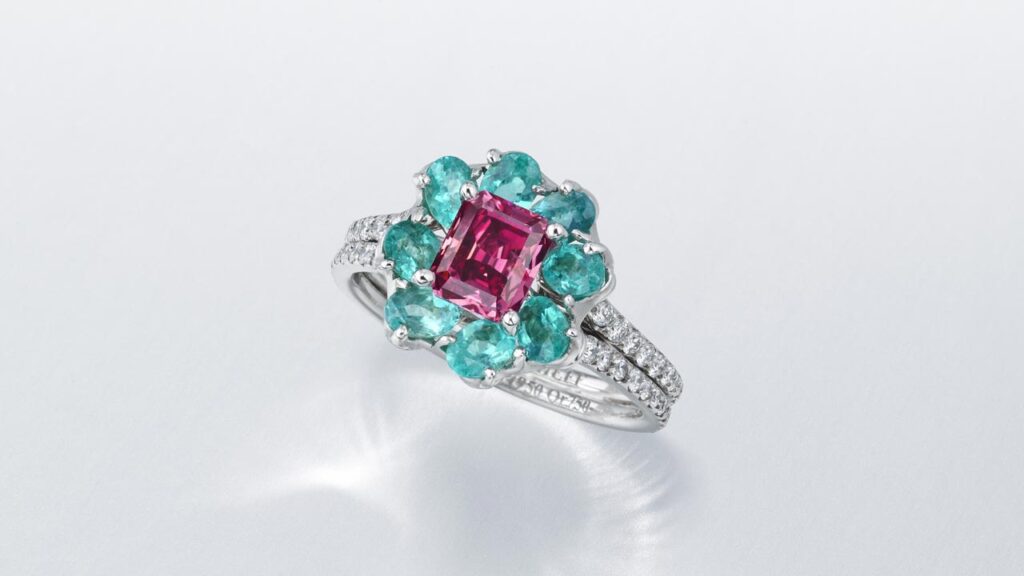 Moussaieff designed, floral ring, with fancy-purplish-red diamond with a round diamond-studded band at Christie's image