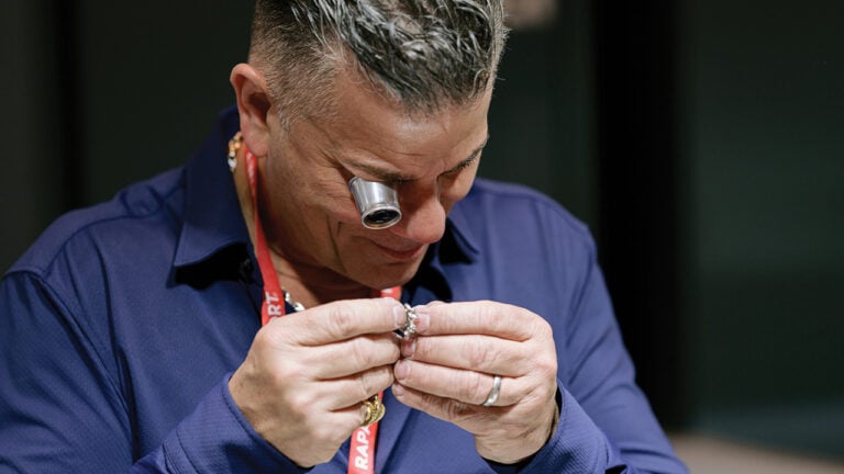 Dealer examining a piece at the Las Vegas Antique Jewelry & Watch Show image