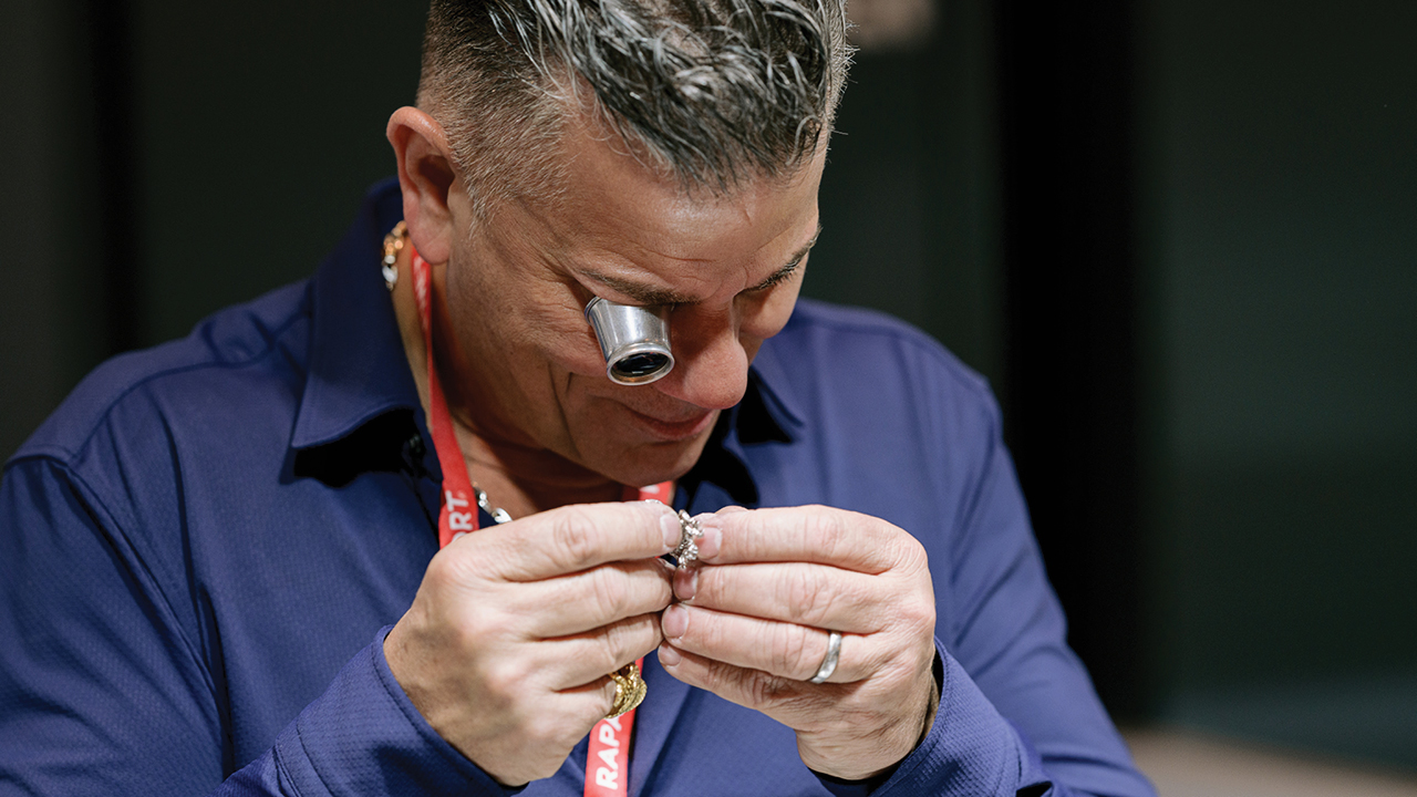 Dealer examining a piece at the Las Vegas Antique Jewelry & Watch Show image