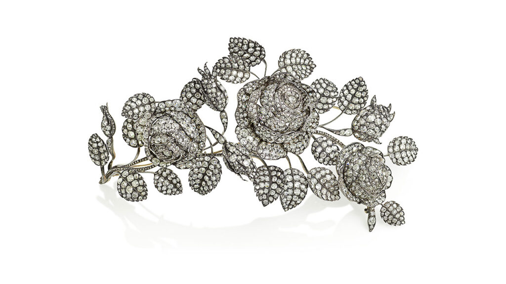 Mid-19th-century brooch featuring three sculptural roses blossoming among buds, set with cushion-cut diamonds in total and rose-cut diamonds at Bonhams image